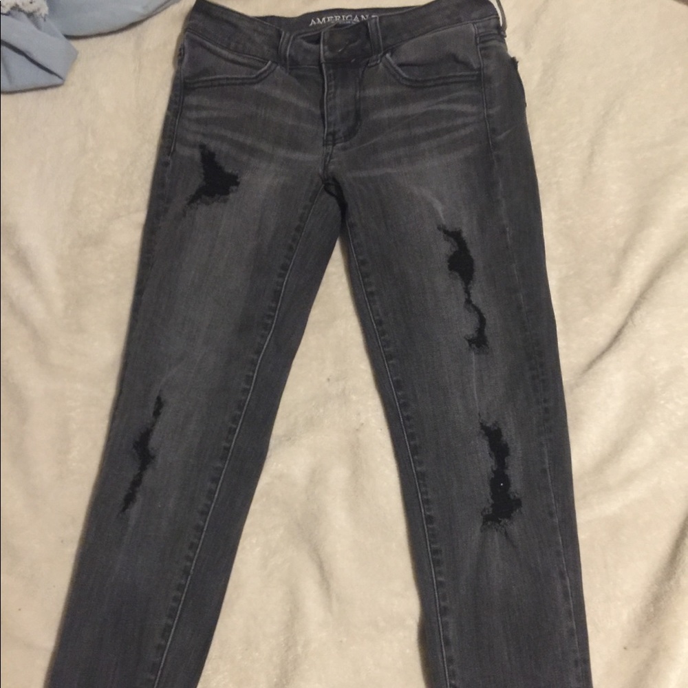 grey and black ripped jeans